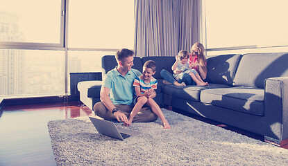 Image showing Happy family playing a video game