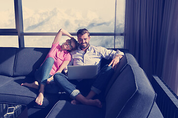 Image showing couple relaxing at  home using laptop computers