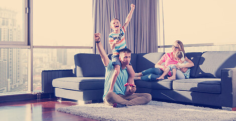 Image showing Happy family playing a video game