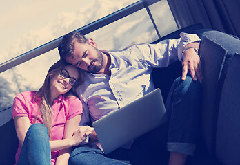 Image showing couple relaxing at  home using laptop computers