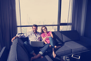 Image showing couple relaxing at  home using laptop computers