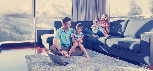 Image showing Happy family playing a video game