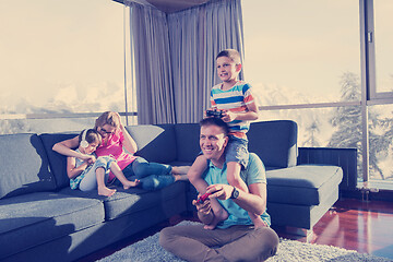 Image showing Happy family playing a video game