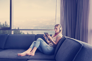 Image showing young girl enjoying music through headphones