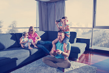 Image showing Happy family playing a video game