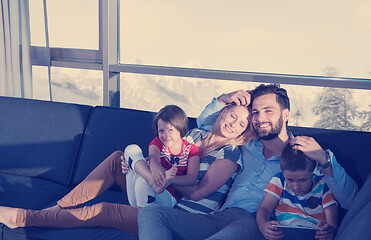 Image showing happy young couple spending time with kids at home