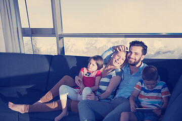 Image showing happy young couple spending time with kids at home