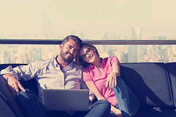 Image showing couple relaxing at  home using laptop computers