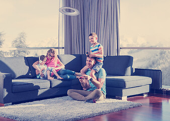 Image showing Happy family playing a video game