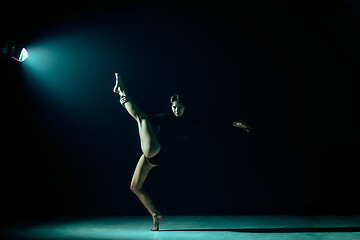 Image showing Young female ballet dancer on neon lights studio background.