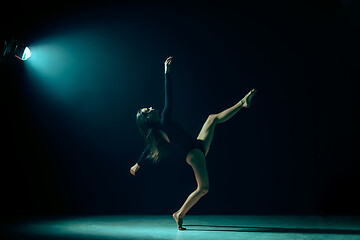 Image showing Young female ballet dancer on neon lights studio background.