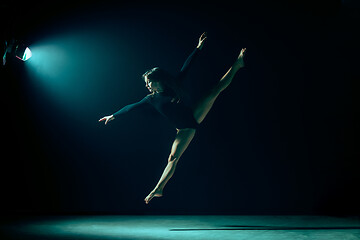 Image showing Young female ballet dancer on neon lights studio background.