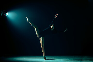 Image showing Young female ballet dancer on neon lights studio background.