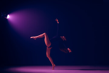 Image showing Young female ballet dancer on neon lights studio background.