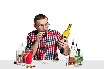 Image showing Expert barman is making cocktail at studio