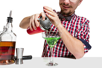 Image showing Expert barman is making cocktail at studio