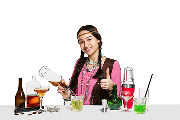 Image showing Expert female barman is making cocktail at studio