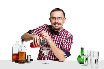 Image showing Expert barman is making cocktail at studio