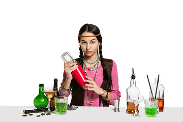 Image showing Expert female barman is making cocktail at studio