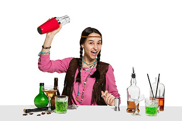 Image showing Expert female barman is making cocktail at studio