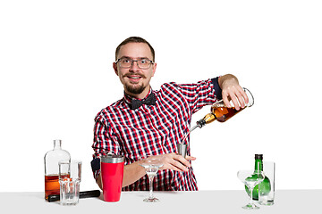 Image showing Expert barman is making cocktail at studio