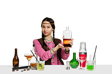 Image showing Expert female barman is making cocktail at studio