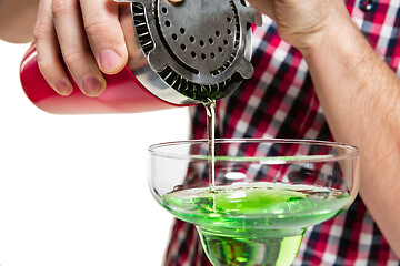 Image showing Expert barman is making cocktail at studio