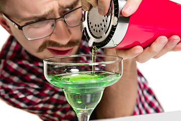 Image showing Expert barman is making cocktail at studio