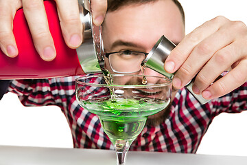 Image showing Expert barman is making cocktail at studio