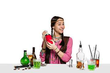 Image showing Expert female barman is making cocktail at studio