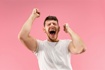 Image showing Winning success man happy ecstatic celebrating being a winner. Dynamic energetic image of male model