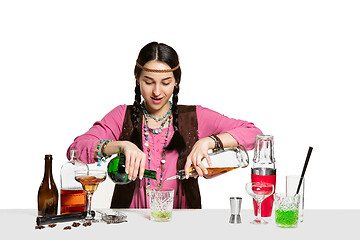 Image showing Expert female barman is making cocktail at studio