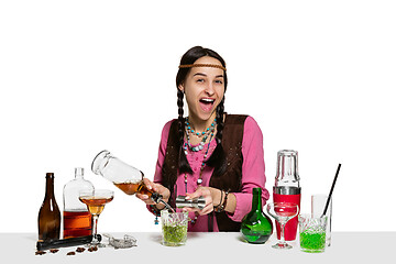 Image showing Expert female barman is making cocktail at studio