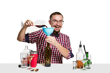 Image showing Expert barman is making cocktail at studio