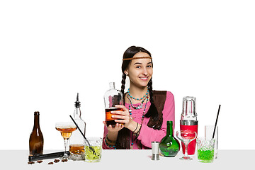 Image showing Expert female barman is making cocktail at studio