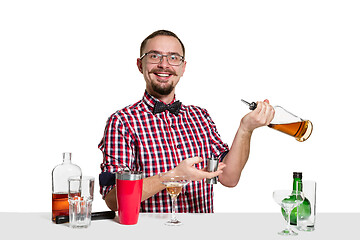 Image showing Expert barman is making cocktail at studio