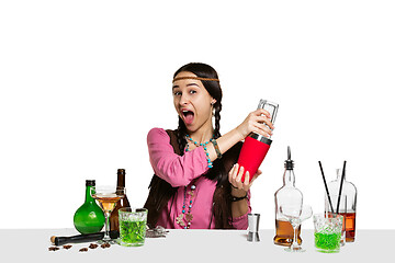 Image showing Expert female barman is making cocktail at studio