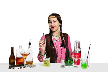 Image showing Expert female barman is making cocktail at studio