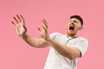 Image showing Portrait of the scared man on pink