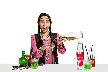 Image showing Expert female barman is making cocktail at studio