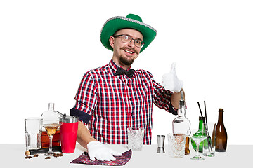 Image showing Expert barman is making cocktail at studio