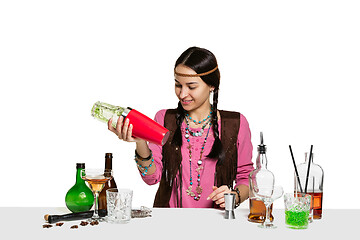 Image showing Expert female barman is making cocktail at studio