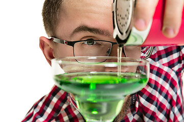 Image showing Expert barman is making cocktail at studio