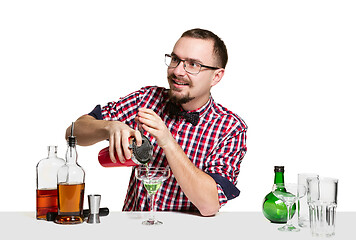 Image showing Expert barman is making cocktail at studio