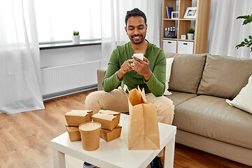 Image showing indian man checking takeaway food order at home