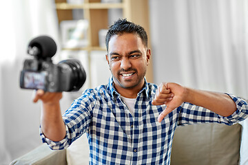 Image showing male video blogger with camera blogging at home