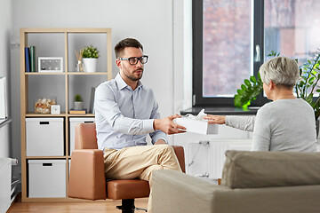 Image showing psychologist giving tissues to senior woman client