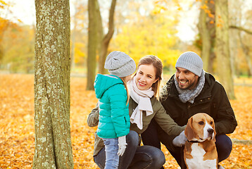 Image showing happy family with beagle dog in autumn park