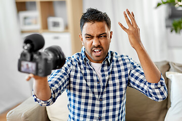 Image showing male video blogger with camera blogging at home