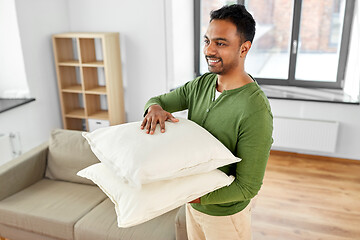 Image showing indian man with sofa cushions at new home